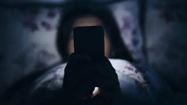 Woman using the phone at night